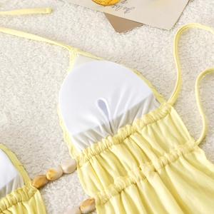 Close-up of yellow bikini with removable pads and marble texture bead details