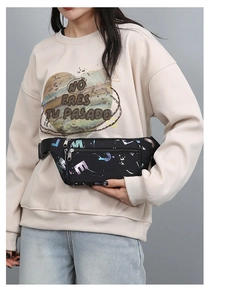 Close-up of black oxford waist bag featuring vibrant colorful letter graffiti and zippers