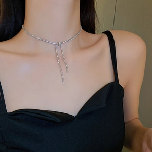 Silver bow necklace with zircon stones shown on neck, elegant sparkling choker detail