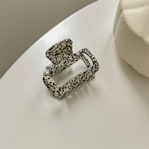 Top view of a square leopard print hair claw clip made of premium acetate on a white surface
