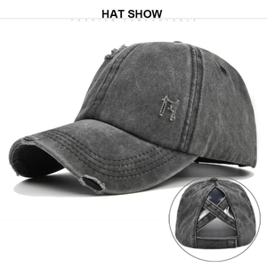 Detail of distressed grey cotton baseball cap with ponytail hole and worn texture