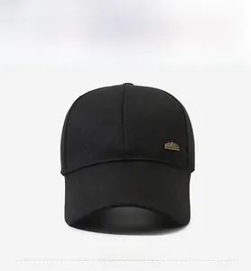 Detailed front view of black baseball cap with golden sports style metal logo emblem