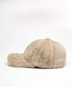 Side view of a plush faux rabbit fur baseball cap in warm beige with a curved brim