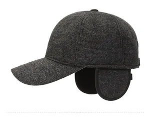 Detail view of winter baseball cap showing thick gray wool texture and metal mountain logo