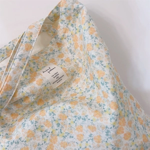 Detail of floral canvas tote bag showing soft cotton fabric texture and chic pattern