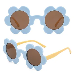 Cute light blue flower shaped sunglasses with brown lenses and bright yellow temples