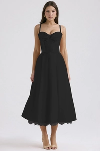 Detail view of black French floral dress featuring corset waist and A-line midi skirt