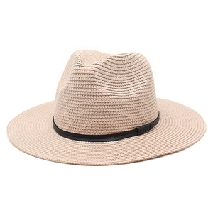Detailed view of the fine straw weave and black ribbon on a beige Panama sun hat