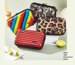 Mini hardshell crossbody bags in rainbow, leopard, and camo prints for storage