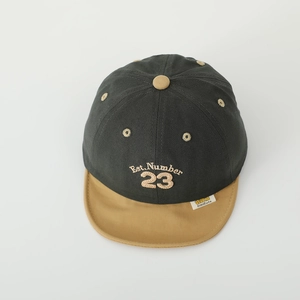 Detail of kids twill cotton cap showing number 23 embroidery and color block design