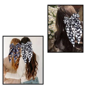 Detail of Halloween hair bows with ghost and pumpkin patterns on long hair ribbons