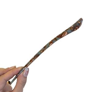 Handmade acetate hair stick with blue-brown tortoiseshell pattern and gold label logo