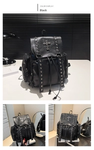 Detail of black faux leather backpack featuring vintage metal cross and silver rivets