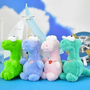 Close-up of four colorful plush dinosaur keychains in green, purple, pink and teal shades