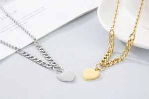Detailed view of silver and gold stainless steel necklaces with hollow heart pendants