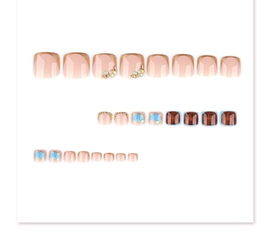 Detail view of foot nail set featuring french gold edges, rhinestones and tortoise texture