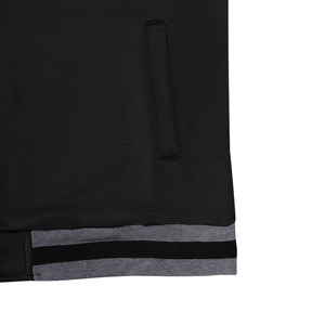 Close-up of baseball jacket pocket structure and striped ribbed hem with smooth texture