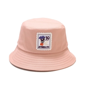 Pink cotton bucket hat with retro stamp embroidery and Je Pense A Toi text on white background