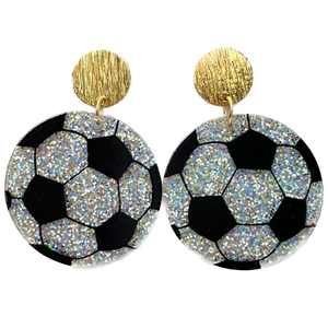 Macro shot of sparkling silver sequin soccer ball earrings with gold metal studs