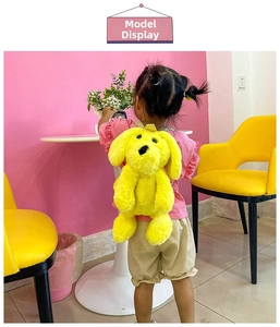 Detail view of a child wearing the yellow plush dog backpack in a bright playroom