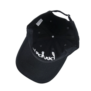 Detail view of the cotton baseball cap's inner label and adjustable metal buckle