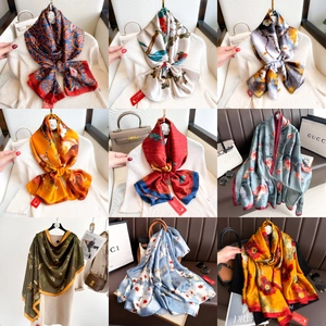 Detailed collage of satin scarves featuring vintage paisley and floral art patterns