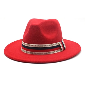 Detail of red wool fedora hat featuring a patterned decorative band and pinched crown design