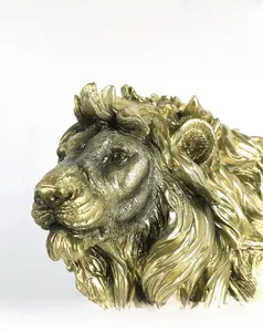 Close-up of golden lion head sculpture showing intricate mane textures and realistic facial details