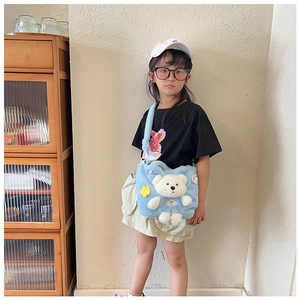 Blue plush crossbody bag for kids featuring a 3D white bear and yellow flower charm