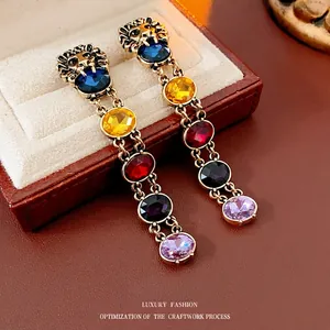 Vintage gold lion head earrings with colorful gemstone fringe and royal palace style finish