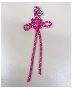 Macro view of pink braided Chinese knot keychain with silver metal ring connector