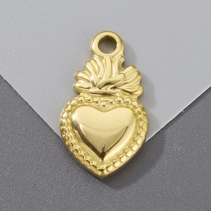 Detailed view of a golden heart pendant with crown design and beaded texture edges