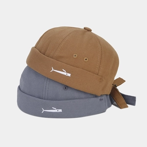 Close-up of high-density canvas docker hats with minimalist fish embroidery details