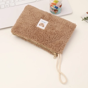 Detail showing the soft light brown teddy fleece fabric and cute bear label of this pouch