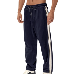 Detail view of navy blue corduroy pants with white side stripes and drawstring waist