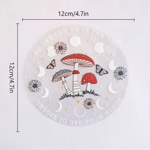 Detail of 12cm circular PVC suncatcher featuring mushroom, butterfly and moon phase designs