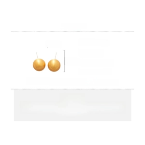 Macro view of brushed golden ball earrings with silver needles and copper material specs