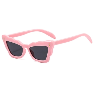 Pink cat-eye sunglasses for women with scalloped edges and gold metal accents on white background