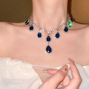 Macro view of blue teardrop crystal pendant with silver rhinestone necklace craftsmanship