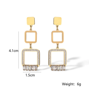 Detail view of gold heart geometric earrings with cubic zirconia and crystal stones
