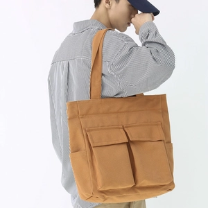 Vintage khaki canvas tote bag with large capacity and multi-pocket workwear design