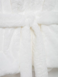 Detail view of the soft white faux fur texture and matching tie belt on this coat