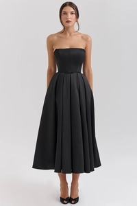 Detail of elegant black strapless satin dress with corset waist and bow ribbon detail