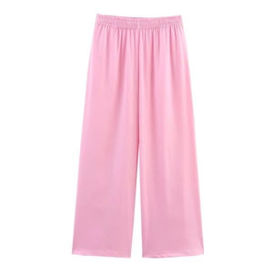Detail of pink elastic waist wide-leg pants with silky satin texture and draped fit