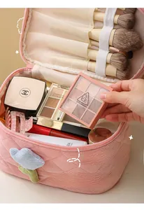 Pink corduroy makeup bag detail with tulip decor and brush slots for daily storage