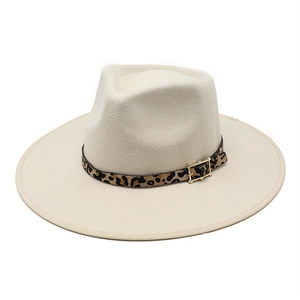 Detail view of a cream fedora hat with leopard print leather band and golden buckle