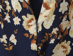 Detail of invisible zipper closure and floral print fabric on a slim fit dress