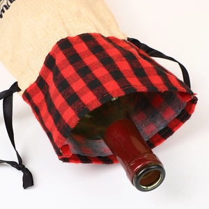 Close-up of linen Christmas wine bottle bag with red and black plaid collar and drawstring