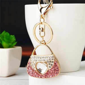 Detail of pink rhinestone handbag keychain with heart crystal and golden lobster clasp