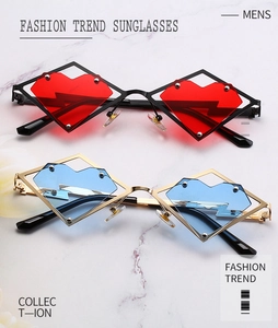 Detail of heart-shaped colored lenses in diamond metal frames on marble background